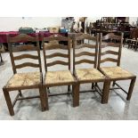 A set of four oak ladderback chairs. Rush seats A.F.