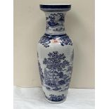 An oriental style vase, decorated in blue and white with a landscape. 24' high