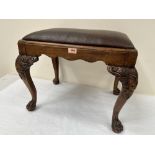 A George II style walnut stool raised on lion carved cabriole legs and paw feet. 23' wide
