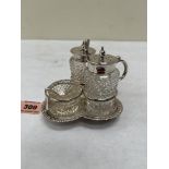 A Victorian silver trefoil cruet stand with cut glass salt, pepperette and mustard pot. The stand