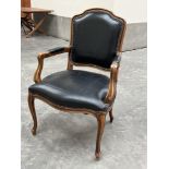 A fauteuil armchair upholstered in black hide. Of recent manufacture