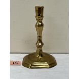 An 18th century brass candlestick with inverted baluster and knopped stem on octagonal stepped base.