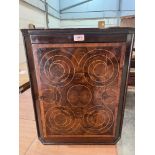 An oyster veneered and line inlaid hanging corner cupboard. 21¾' high