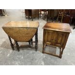 An oak barleytwist dropleaf table, 30' wide and a small oak cabinet