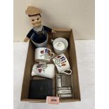 A box of sundries to include a Norah Wellings type doll, crested ceramics, lighters etc.