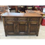 An oak sideboard with three drawers over conforming linenfold doors. 54' wide