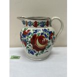 A 19th century creamware pitcher, brightly painted in enamels with foliage. 6¼' high