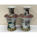 A pair of Chinese famille-rose vases, with continuous decoration of sages and officials in a