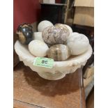 A marble bowl with 12 hardstone eggs