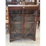 A mahogany bookcase enclosed by a pair of astragal glazed doors. 36' wide