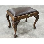 A George II style walnut stool raised on lion carved cabriole legs and paw feet. 23' wide