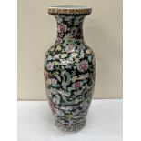 A Chinese famille-rose vase, painted with dragons and chrysanthemums on a black ground. 25' high.