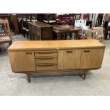 A 1960s Greaves and Thomas teak 'long John' sideboard, 69' wide