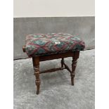 A Victorian rosewood piano stool with rise and fall seat