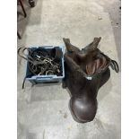 Two leather saddles and a box of tack