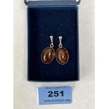A pair of silver and amber earrings, the amber cabochons 17mm x 12mm approx