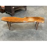 Reynolds of Ludlow. A yew wood low table with naturalistic top. Bears maker's label. 54' long