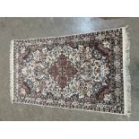 An Indian cream ground silk rug. 60' x 36'