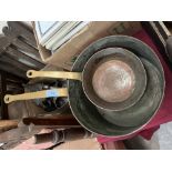 Two copper saucepans with brass handles, the larger 10' diam