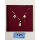 An emerald and diamond pendant and earrings en-suite