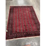 A Bokhara red ground carpet. 96' x 131'