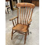 A Victorian lath-back elbow chair on ring turned legs