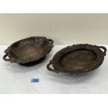 Two carved treen Black Forest type dishes, the bases with musical movements playing on air. The