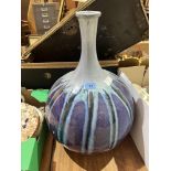 A studio pottery globular vase painted in mottled shades of blue, green and mauve. 18½' high