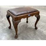 A George II style walnut stool raised on lion carved cabriole legs and paw feet. 23' wide