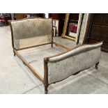 A French walnut and upholstered bedstead. 4'10' approx.