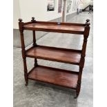 A Victorian mahogany three tier buffet with galleried stages, turned uprights and finials. 35'
