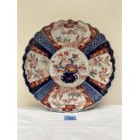 A Japanese Imari charger, typically decorated in reserves with trees and foliage. Meiji. 12' diam