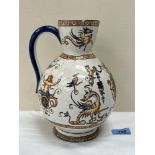A French Gien faience jug, decorated with putto, caryatids and mythical beasts. 9' high. Chip to