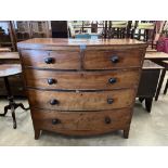 A George III mahogany bowfronted chest of two short over three long drawers on splayed bracket feet.