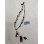 An amber multi-strand necklace with five naturalistic drops