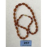 A necklace of facetted graduated amber beads. 11g. 19' long