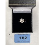 A 9ct seven white stone cluster ring. 2.3g gross. Size J