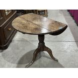A Georgian oak dropleaf tripod table 31' diam. Loss to foot. Converted to a dropleaf at a later