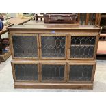 A Minty oak bookcase enclosed by six leaded glazed doors. 53'w x 40'h