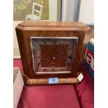 A walnut mantle clock striking and chiming on nine tubular gongs. 9' high