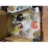 Two boxes of glass paperweights