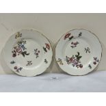 A pair of 19th century plates painted in enamels with scattered flowers. 9½' diam.