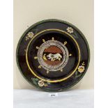 An 18th century slipware bowl, the centre decorated with a bear. 12' diam. Old rivetted repairs