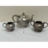 An early 20th century Burmese 800 silver tea service, comprising teapot, sucrier and milk jug,