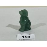 A carved jade seated dog. 2' high