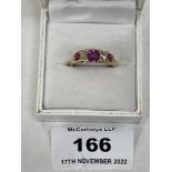An early 20th century 18ct ring set with two old cut diamonds, three rubies and eight diamond chips.