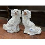 Two 19th century Staffordshire white glazed spaniels. 12½' high