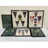 A collection of badges and pennants in six frames