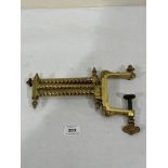 A 19th century gilt brass table clamp for a candle holder or oillamp. 22' long extended