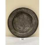 A 19th century eastern metal dish, chased with a battle scene. 8¾' diam.